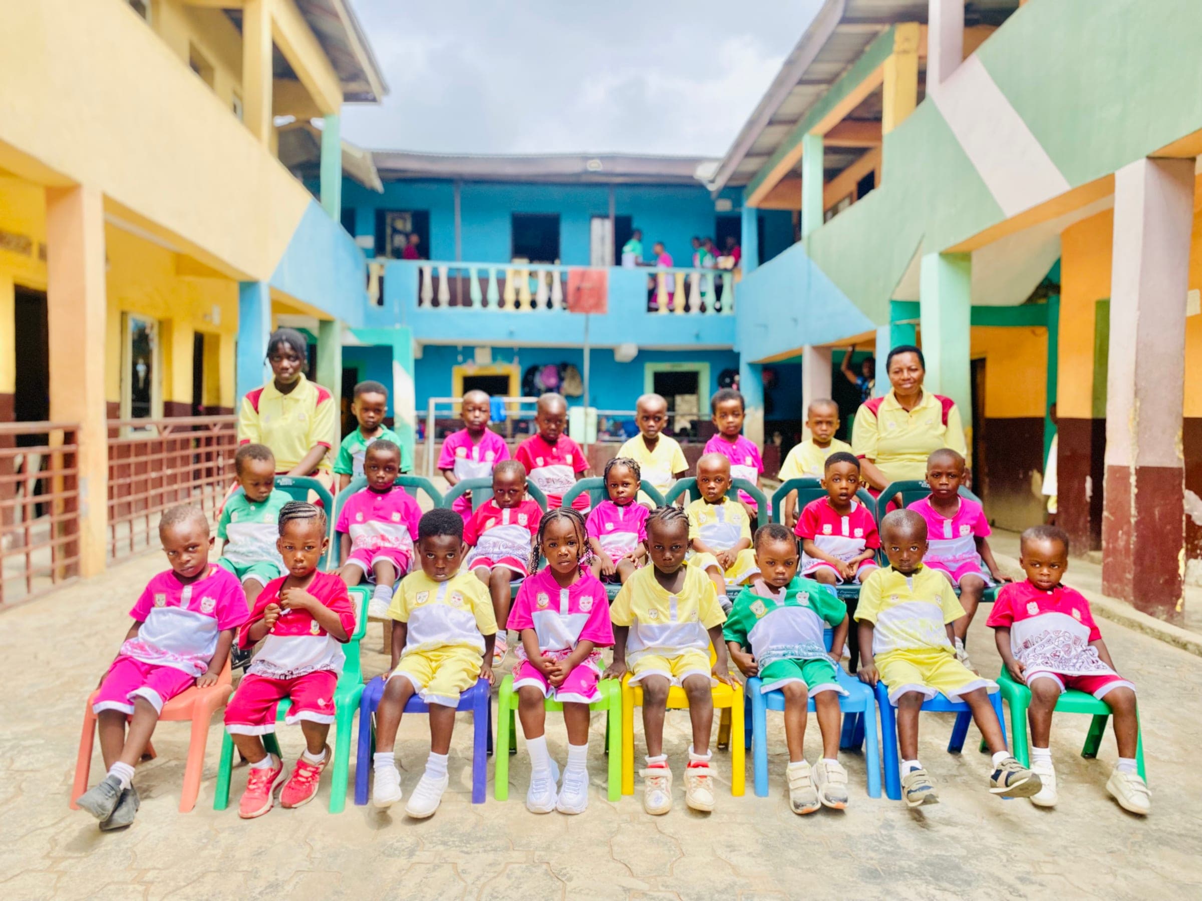 Nursery and primary pupils in house sports kit gathered for a group photograph