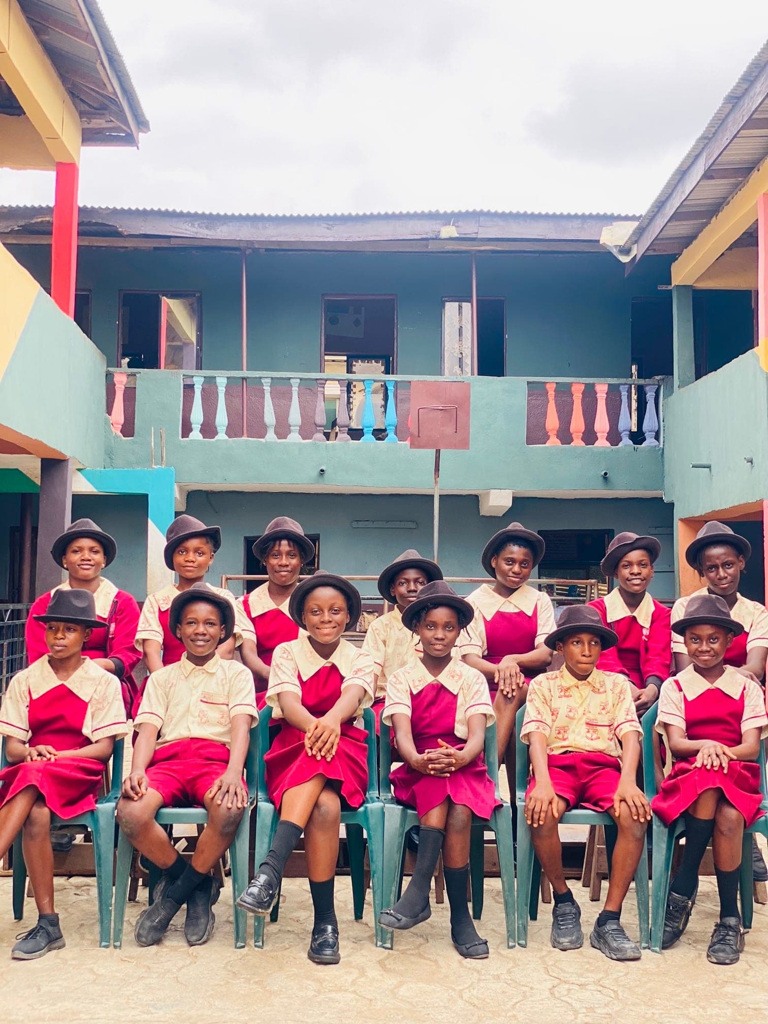 Junior secondary students seated for a class photograph in school uniform