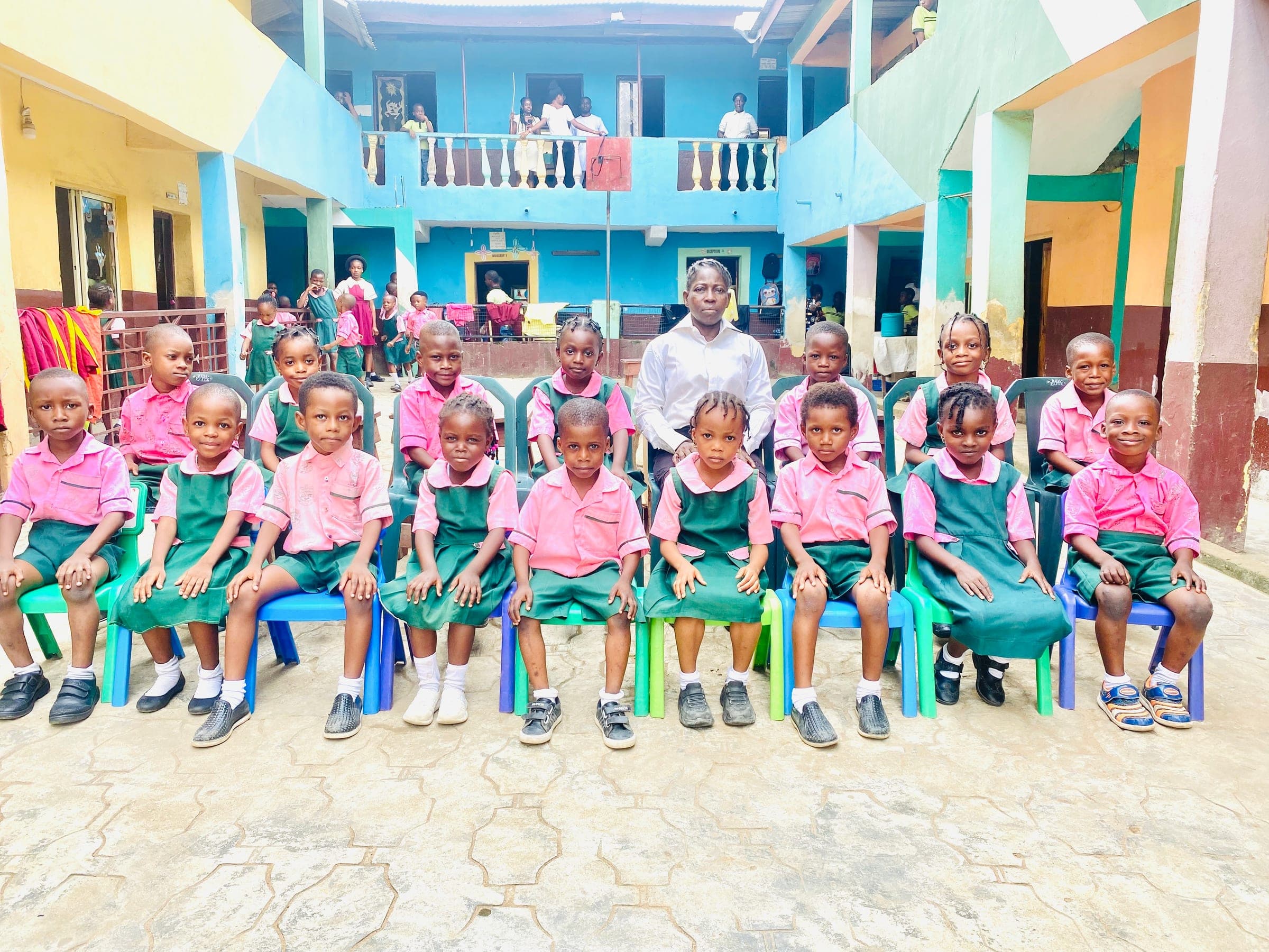 Nursery pupils seated for a class photograph with their teacher