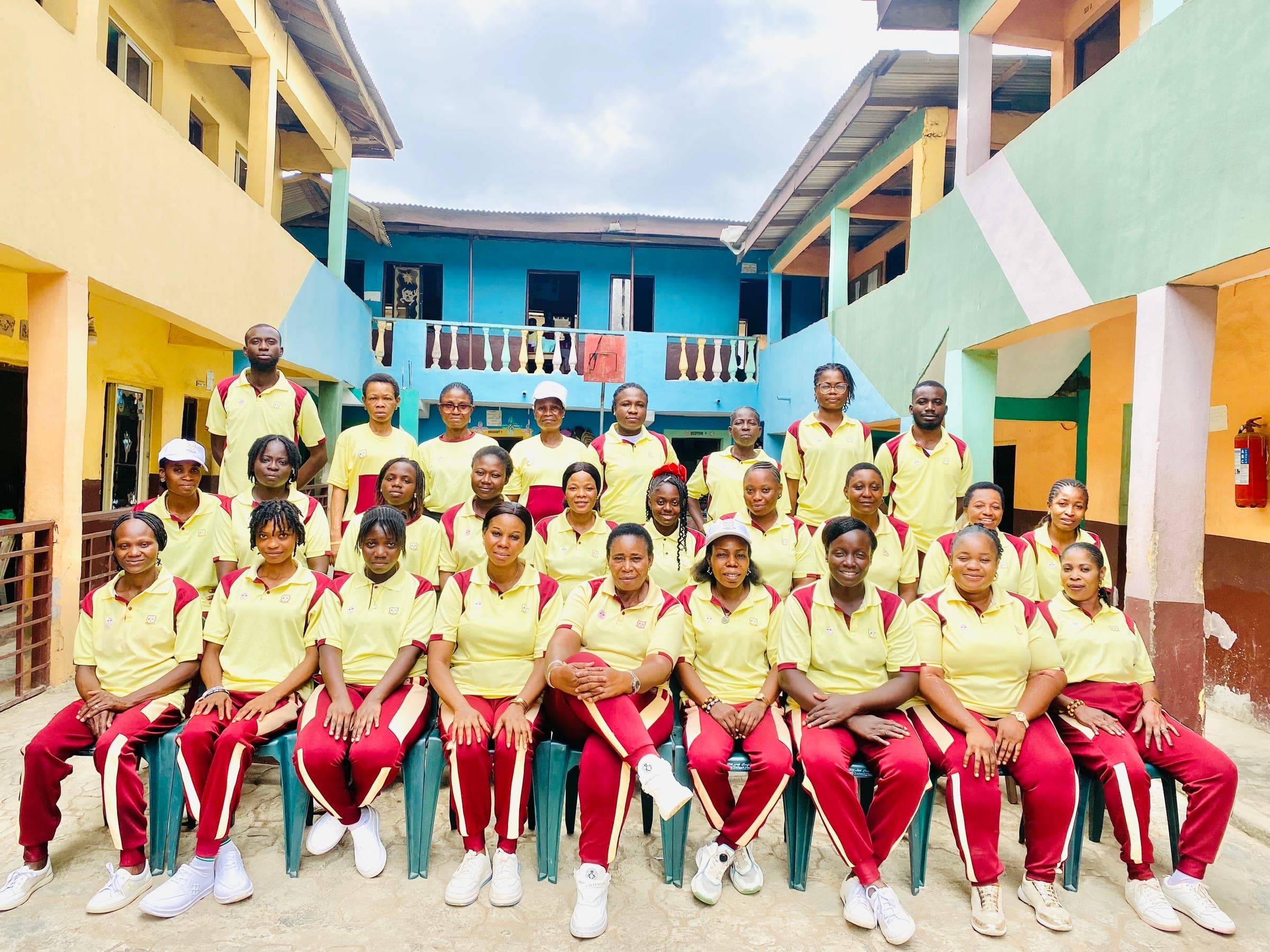 Staff of the school in the yellow and wine sports kit on inter-house sports day
